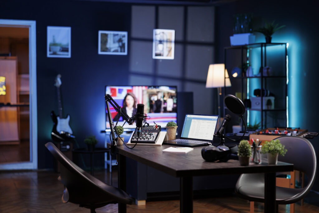 Vacant room with podcast equipment to record talk show at home. There are no people in the living room, used for online vlogging and broadcasting discussions using a microphone and sound production.