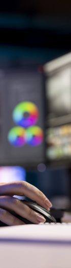 Video editor trimming segments of drone shot footage, working on promotional clip project, close up. Videographer splicing film pieces, editing them using professional software on computer